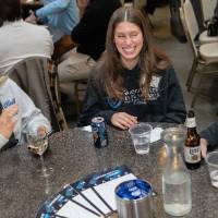 Group of woman sitting together at table, chatting together and laughing